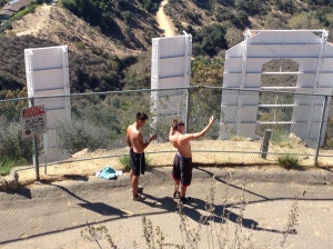 Two teens stripped bare-chested and scaled the fence. They took photos right before they went over.
